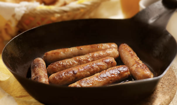 Breakfast sausage links in a cast iron pan